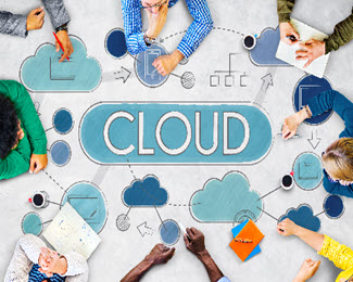 Workmates sitting around a table that is labeled: Cloud
